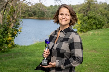 2023 Go Beyond Candice SweetIMG_9931 Woman holding a trophy outside.