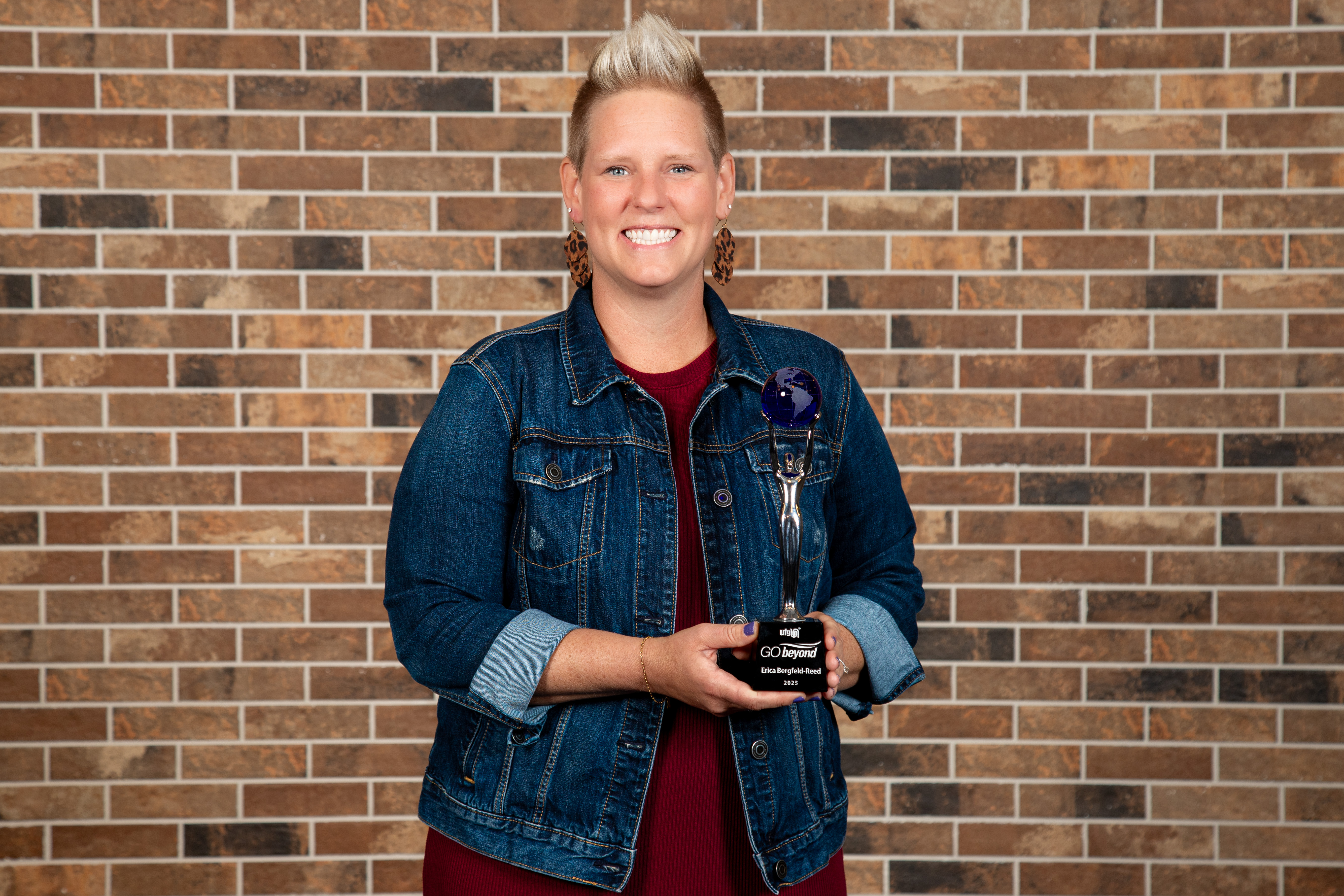 Woman smiling at camera with award.