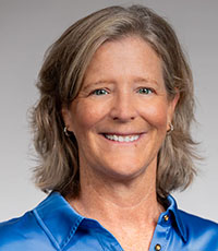Woman wearing blue smiling.