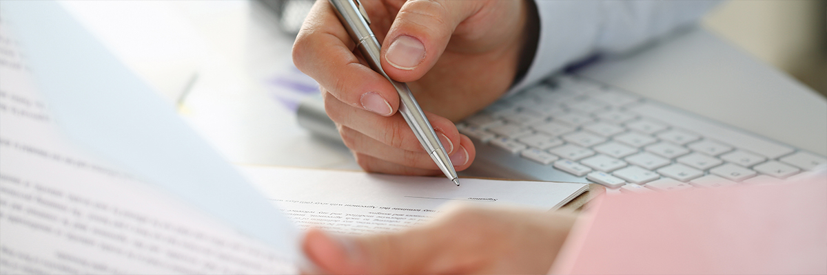 Premium audit insurance underwriter examining documents